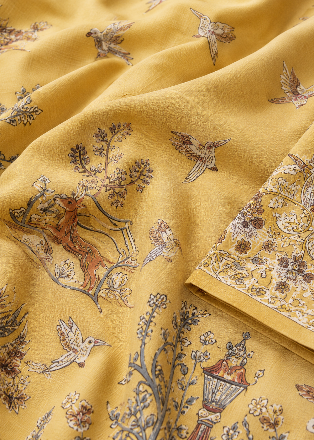 Yellow fabric with intricate floral and bird pattern